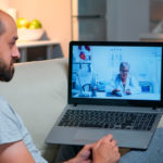 caucasian male chatting with physician doctor during online telemedicine consultation