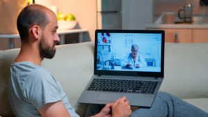 caucasian male chatting with physician doctor during online telemedicine consultation