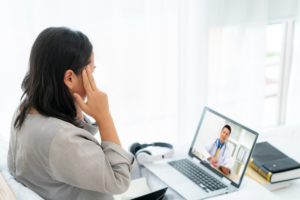 Woman speaking to therapist during telehealth therapy